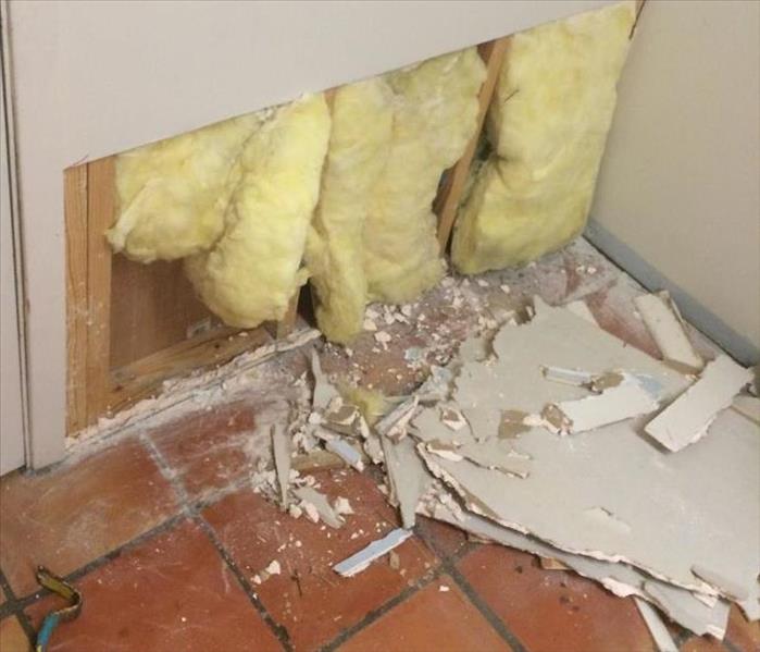 wall opened up with insulation exposed